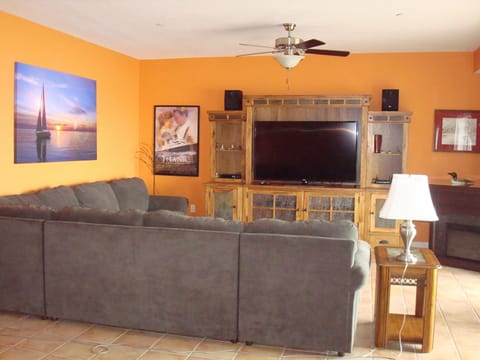 Living room with large sectional and entertainment center 
