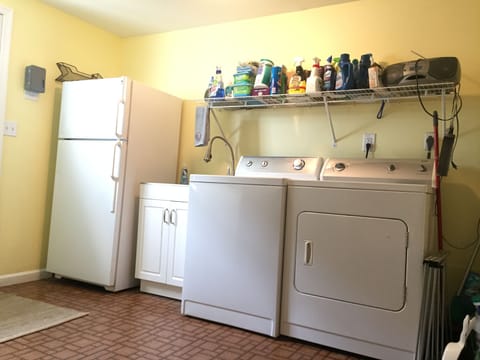 Laundry room with additional refrigerator 