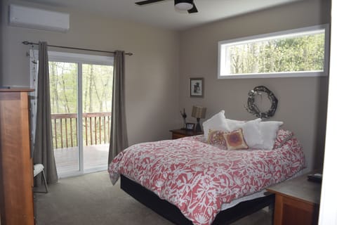 Master bedroom that opens to the back deck, wooded area, and sweet running creak