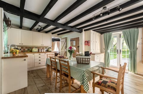 Country kitchen with doors both sides leading on to gardens