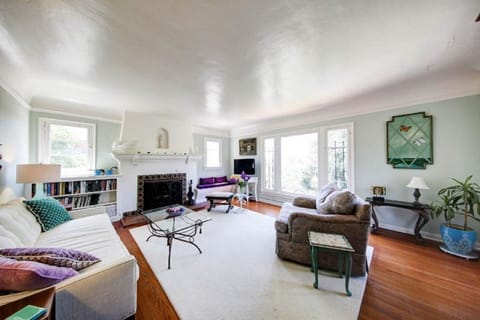 Sunny living room offers light from 3 sides, smart tv, working fireplace.