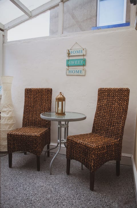 Kitchen leads to undercover seating area. There is also a washer and freezer.