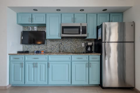 Fresh aqua cabinetry in the kitchenette! 