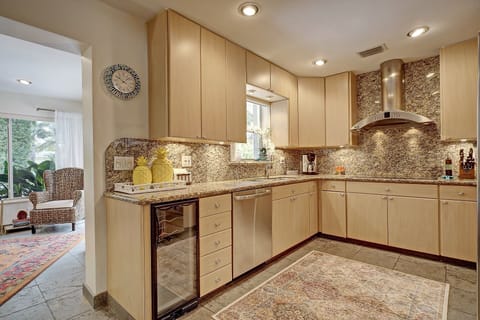 fully stocked kitchen with wine chiller and pass through to outdoor eating