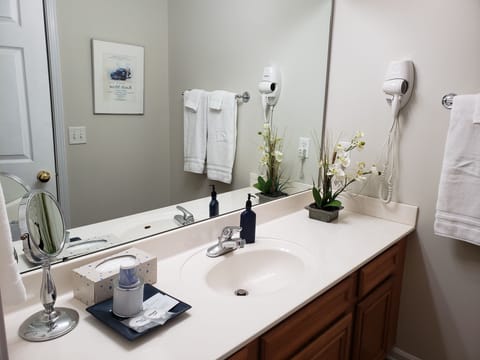 King bathroom vanity.  Hair dryer, towels, small guest gifts. 