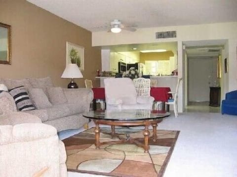 View from patio shows living room, dining room and kitchen: open floor space.