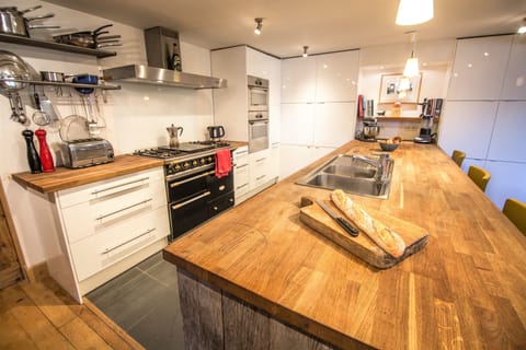 Large well equipped kitchen features Lacanche range