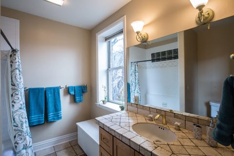 Bathroom has bathtub/shower and window blinds (open for pic)