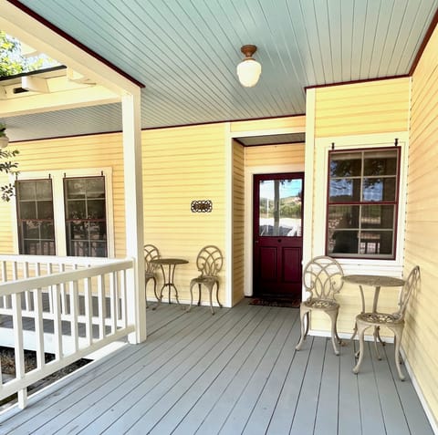 Farmhouse entry and wrap around porch offers multiple seating opportunities