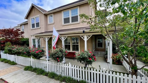 Front of home with rows of roses