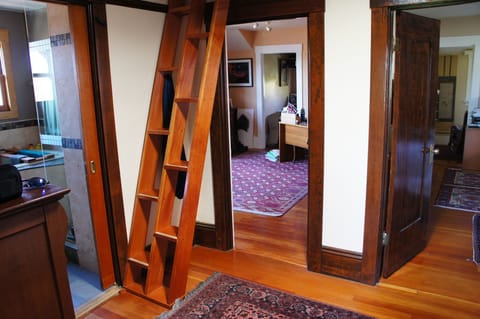 Upstairs landing, entry to shared bathroom, Japanese stairs to the sleeping loft