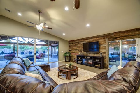 Great Room with Curved HD Smart TV looks out onto the patio & pool area