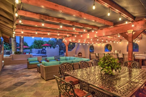 Huge Outdoor Covered Patio with hanging lights and lot's of patio furniture.