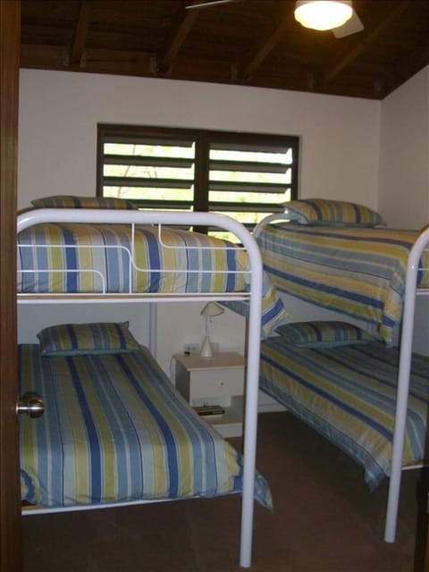 Two rooms with 4 bunk beds each and separate bathroom.