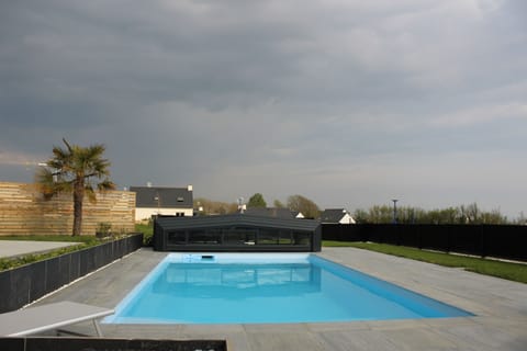 A heated pool, sun loungers