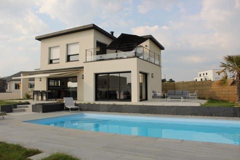 A heated pool, sun loungers