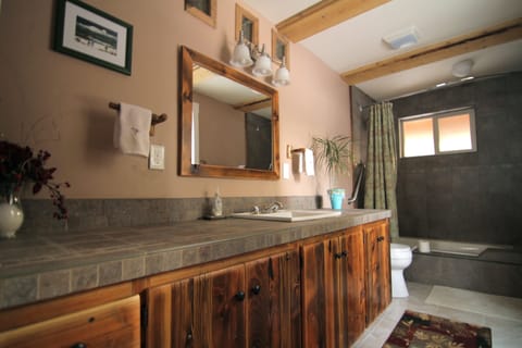 Master bathroom is tiled, with bathtub and shower. Handcrafted throughout.