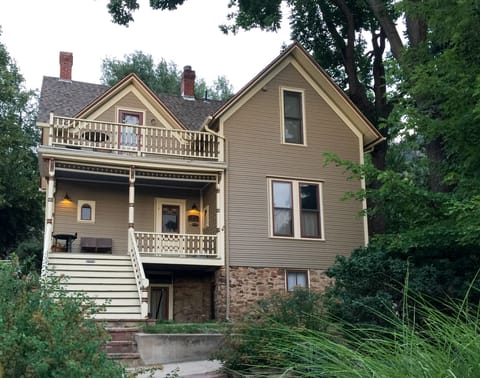 View of house and apartment from the street. Apt entry to right of stairs.