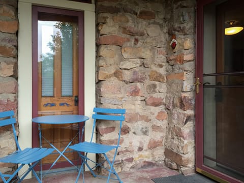 A few steps down and enter through the beautiful, original stone exterior
