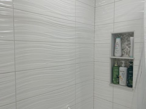 Combined shower/tub, hair dryer, towels, toilet paper