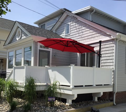 Private porch with seating and adjustable umbrella