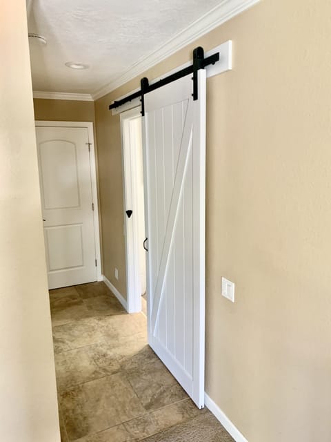Sliding barn door for added space and privacy in the master bathroom