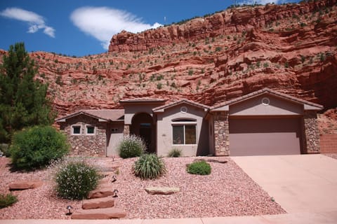 House backs up to stunning cliffs, and faces more red mountains across canyon.  
