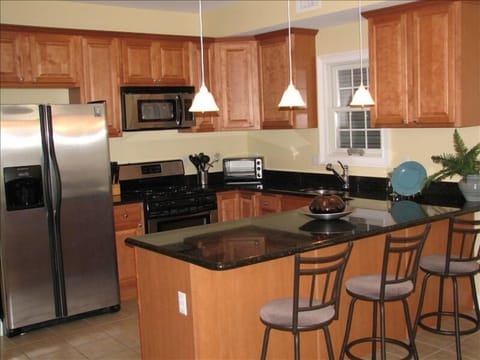 Beautiful modern kitchen with huge island and stainless steel appliances.