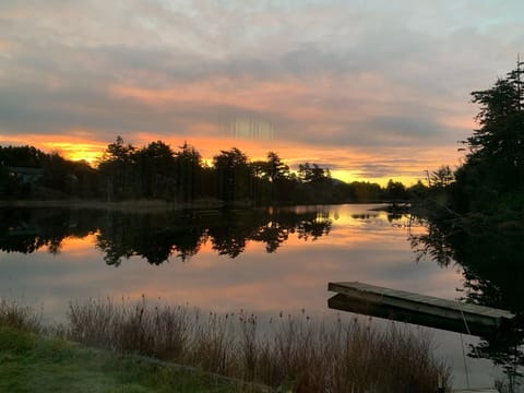 SUN COMING UP OVER THE LAKE