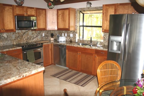 Upstairs kitchen with stainless steel appliances and granite counters