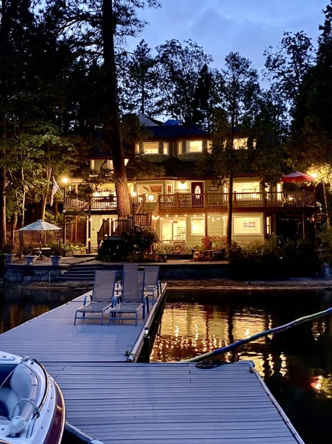 Night time view of the house from the lake in the summer.