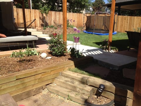 Backyard with view of sunken trampoline.