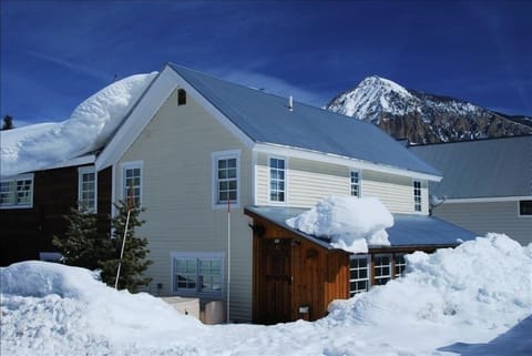 House with Mt Crested Butte to the back. Free bus for ski slopeside delivery.
