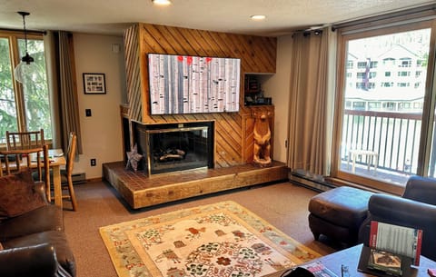 Pull-out couch, love seat,  and chair. Sliding glass door to deck. Game table.