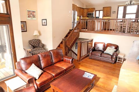 Living room with stairs to Kitchen and Dining room