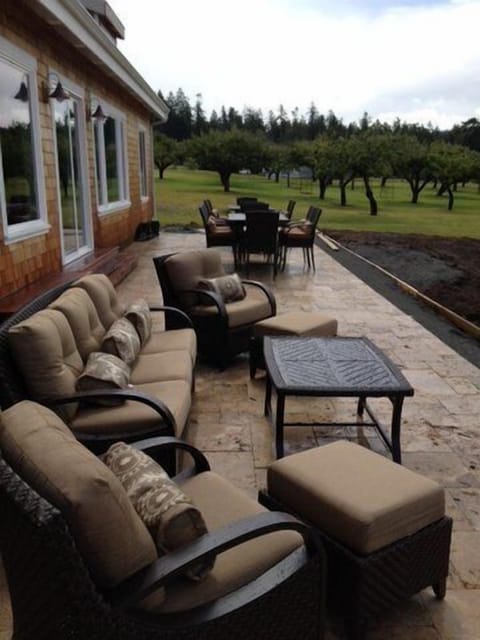 Huge 1,300SF travertine patio with outdoor furniture and 2 dining sets
