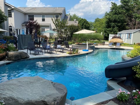 50+ foot heated pool with large tanning ledge, jumping rocks, waterfalls, slide