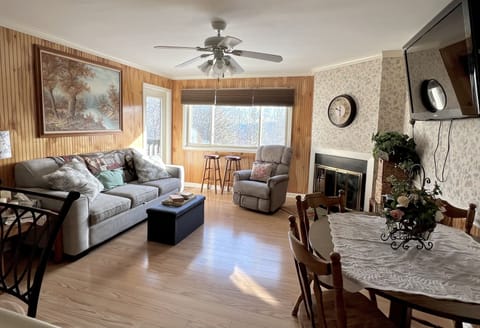 Living room with Big flat screen TV, Electric Fireplace that heats & looks real