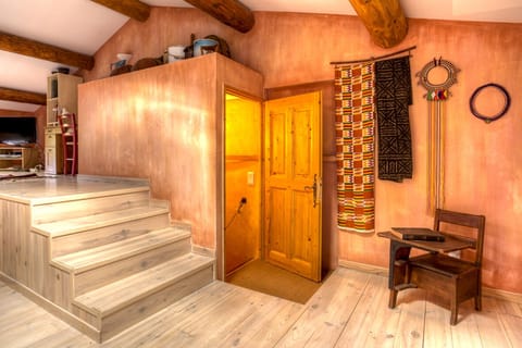 Third floor room, open beamed ceiling, view of access staircase