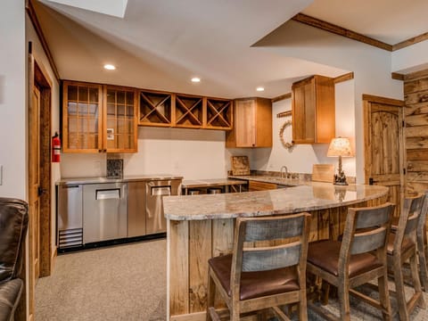 Basement bar with back bar cooler, sink and dishwasher
