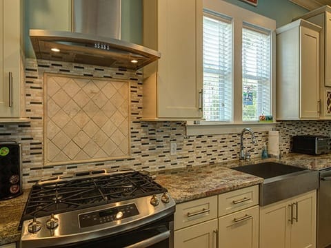 Gas stove and custom tile back splash. Granite counters & custom cabinetry.