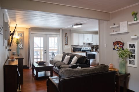 Living room featuring two couches, coffee table, and brand new 65-inch smart TV