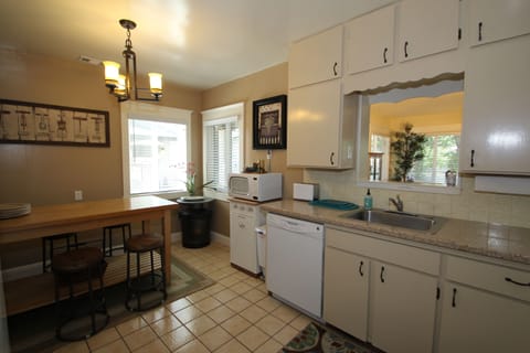Kitchen with dishwasher, microwave, features granite countertops.