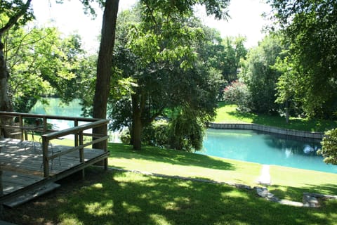 Sit on the large deck and watch the family enjoy the turquoise Comal  
River.