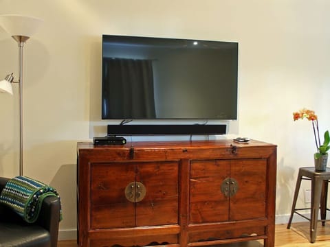 55 inch TV with surround sound bar in living room.