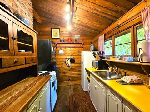 Corridor/Galley kitchen with 4 burner stovetop, oven, microwave, drip coffee maker, knife set, fridge, freezer, cookware, dishes, glassware and more....