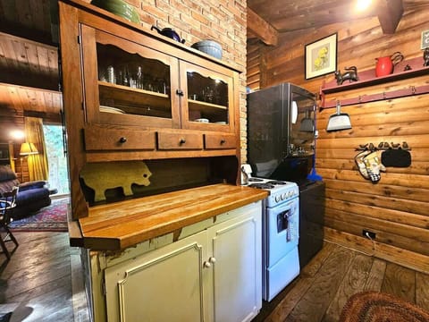 small prep area with dishes above and cookware below.