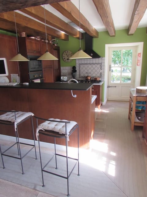 Countertop with bar stools and kitchen with its own entrance door