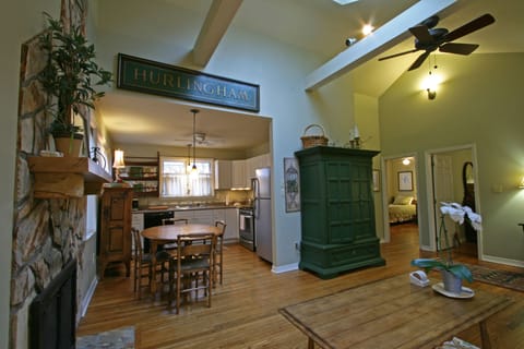 standing in front of french doors, looking toward kitchen, and bedrooms to right