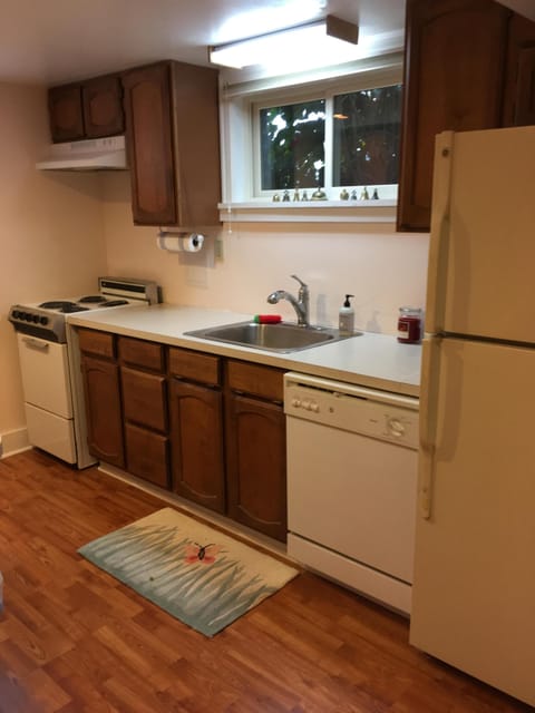 Right side of kitchen with full refrigerator, dishwasher and stove